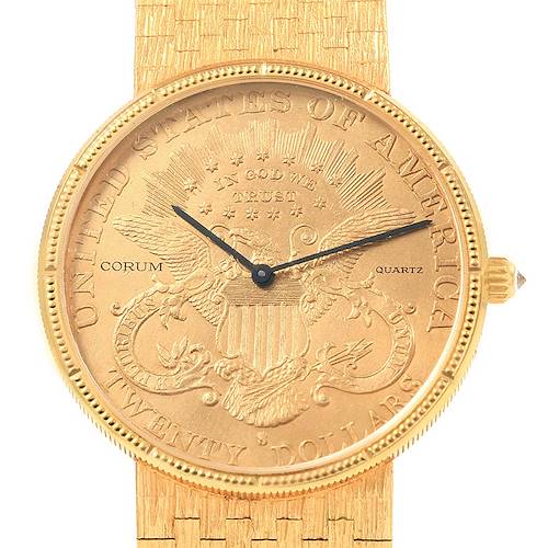 The image shows a close-up of the Corum Coin Watch Men's Yellow Gold Black Dial Men's Yellow Gold Black Dial model, highlighting the intricate gold face, bezel, and textured band.