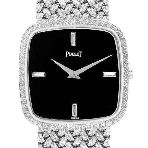 The Piaget 9771D2 men's watch is shown from a front angle, displaying the black dial, silver indices, hands, and part of the textured bracelet.